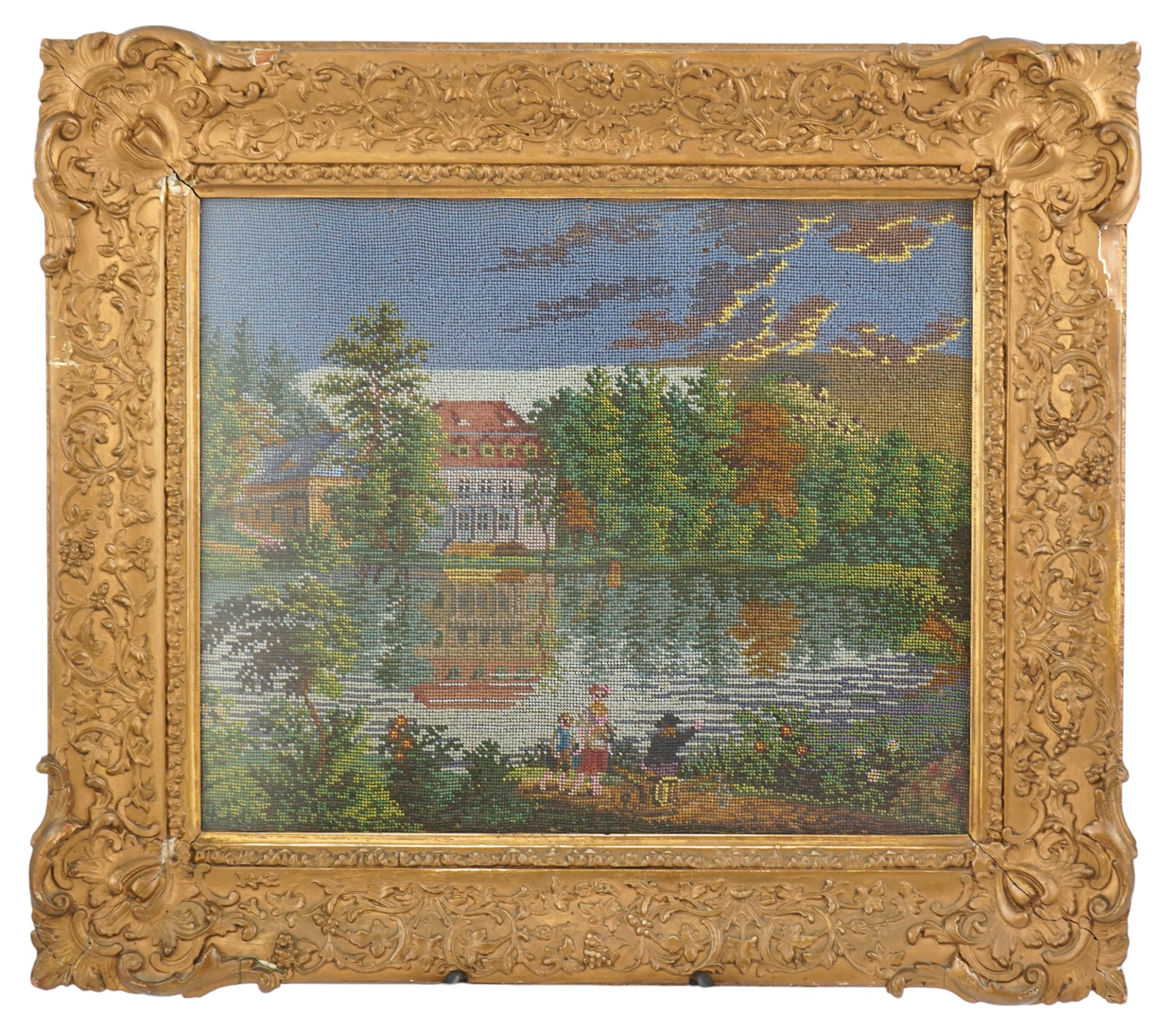 A 19th century framed Berlin beadwork panel, possibly German, country scene of a family walking along a garden path, away from a large lake and mansion surrounded by a forest of fire trees. 26cm wide x 30cm high. Conditi